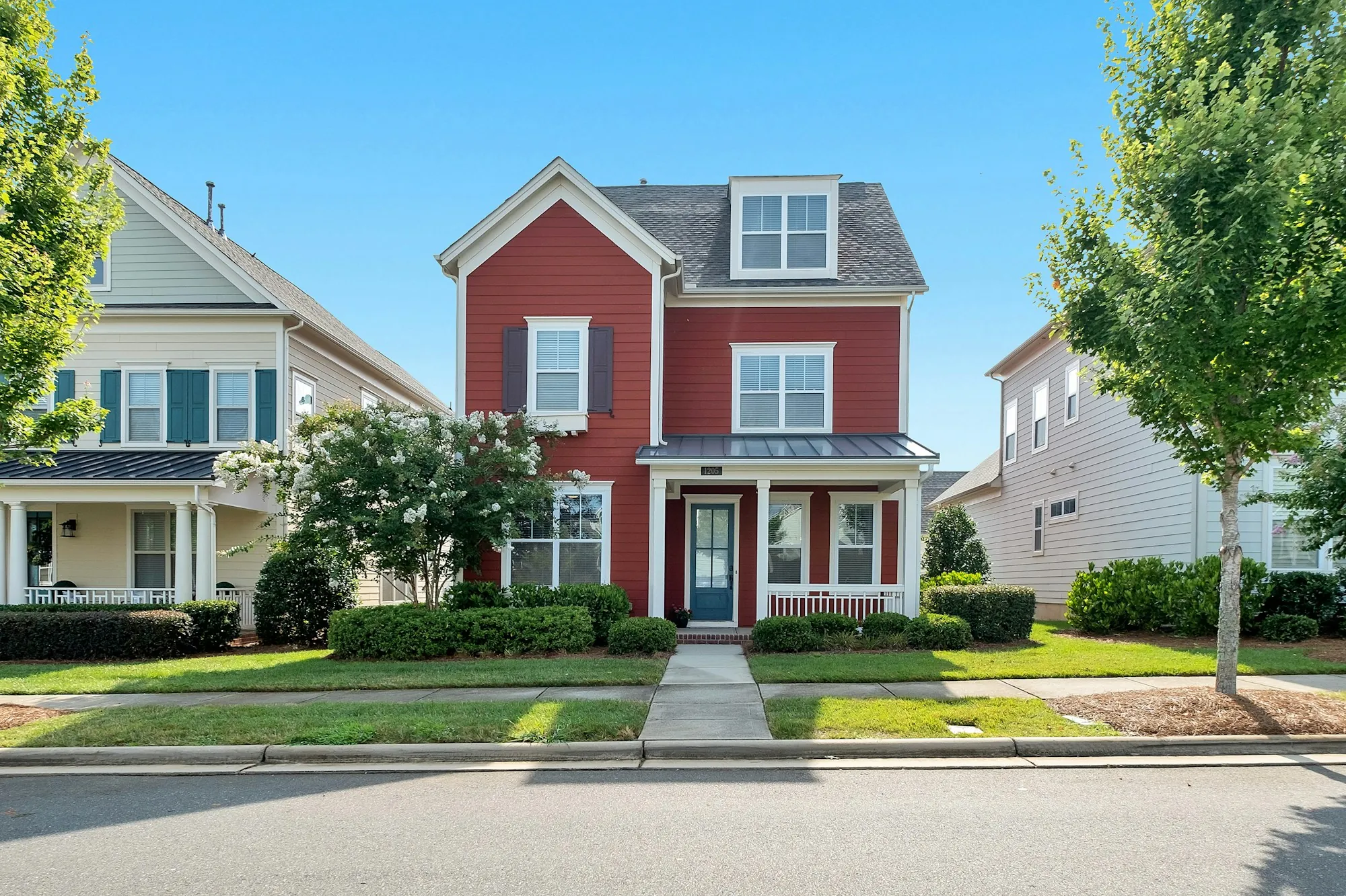 Red two-story house on a residential street