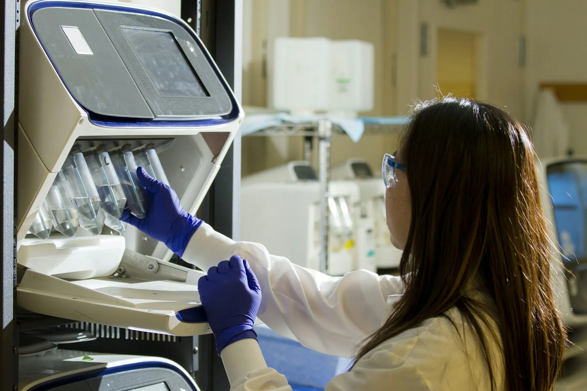 Lab technician loading samples into an instrument